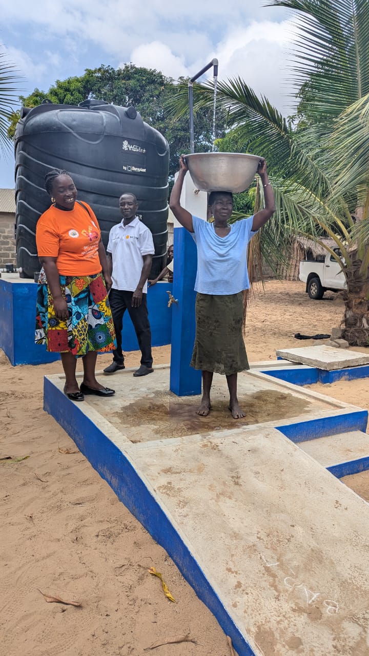 Community member accessing water from the Ghana Water extension point at Amemeliokope, Anloga District.
